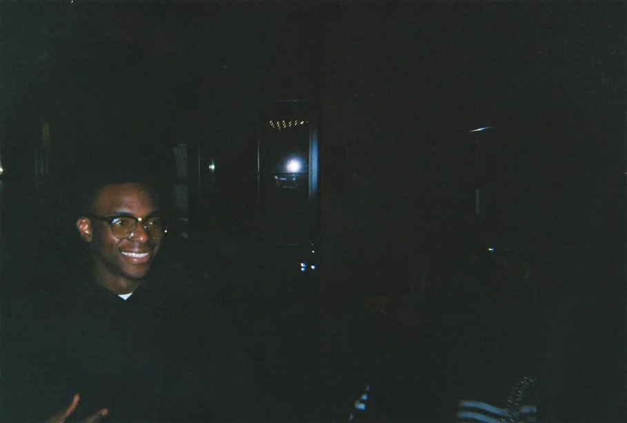 Fathin smiling in a candid low-light photograph