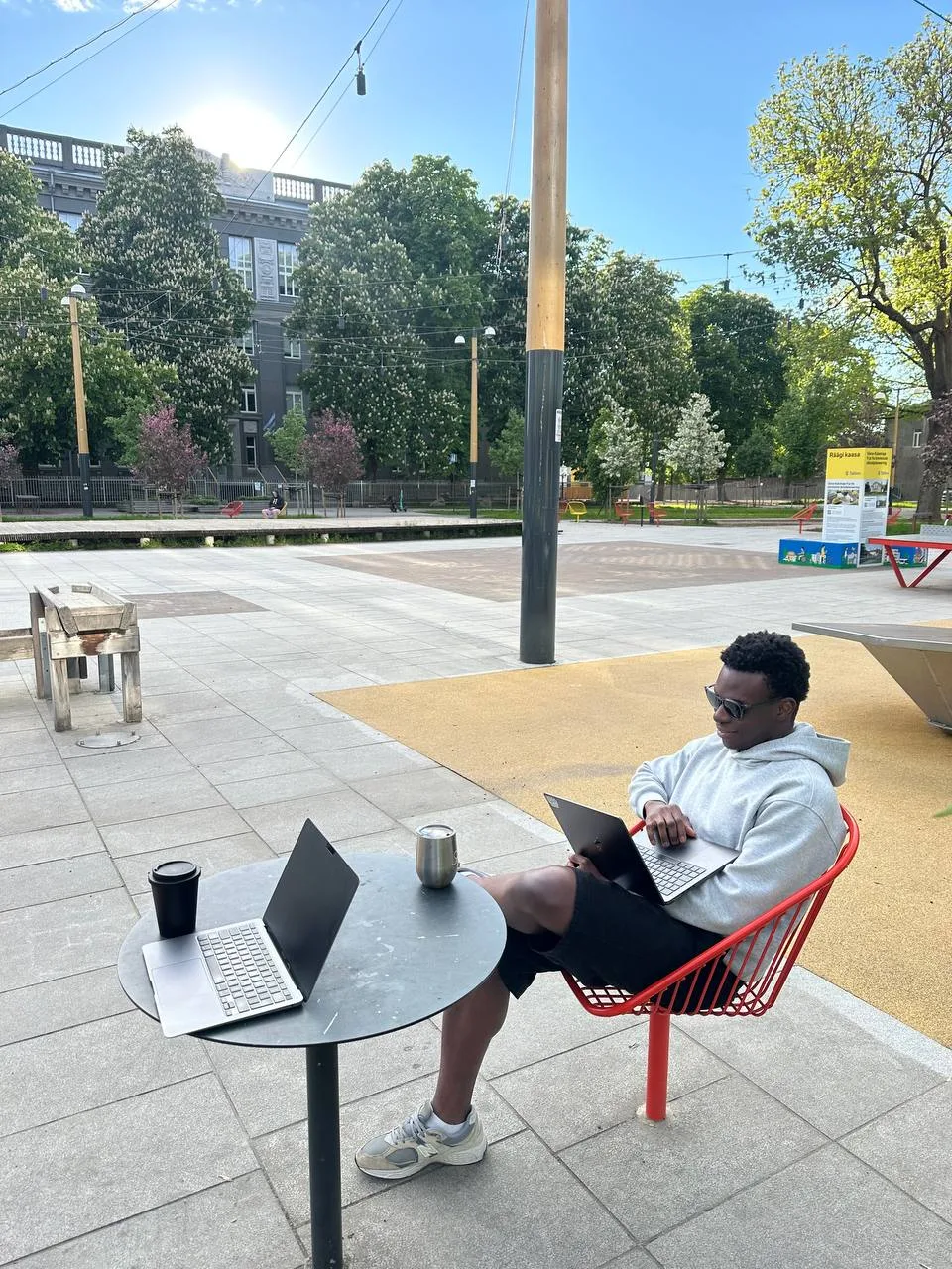 Fathin working on a laptop outside