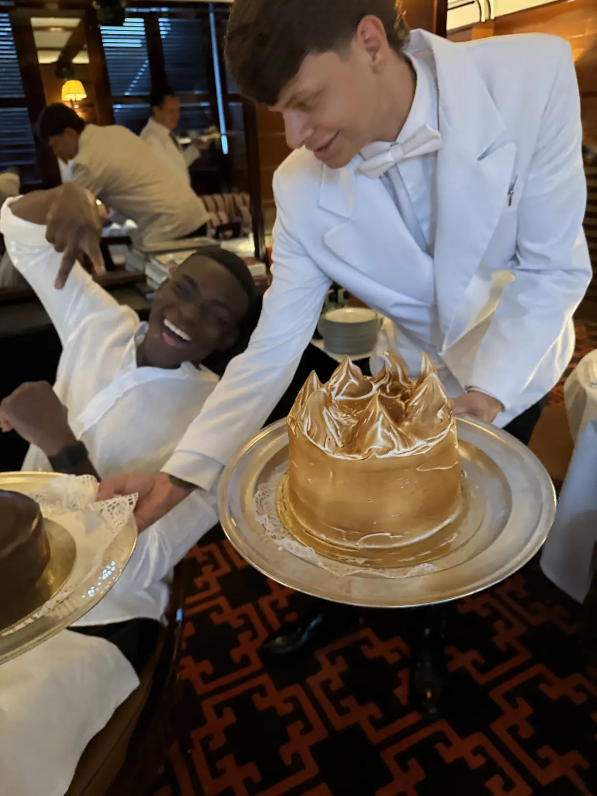 Fathin laughing beside a celebratory cake