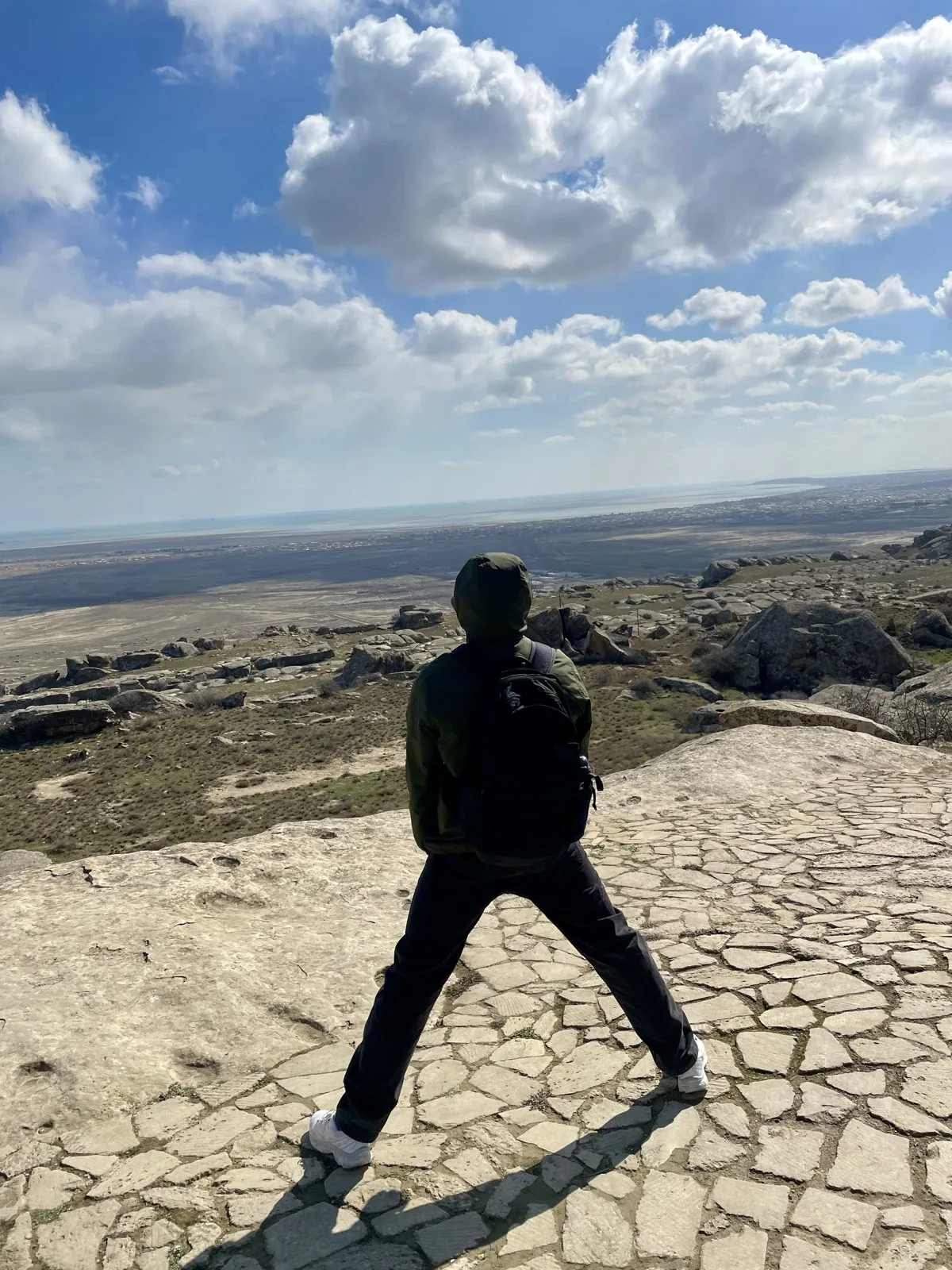 Fathin looking out over a rocky mountain landscape