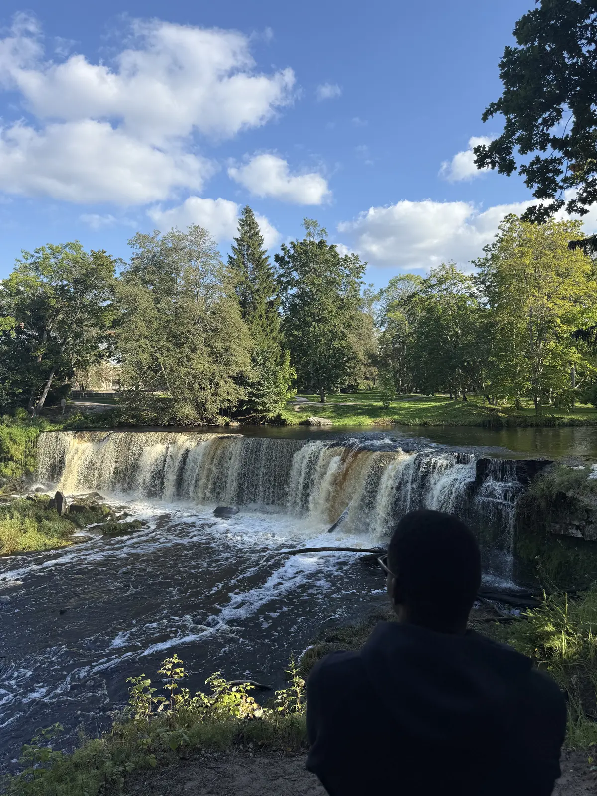 Fathin looking toward a waterfall